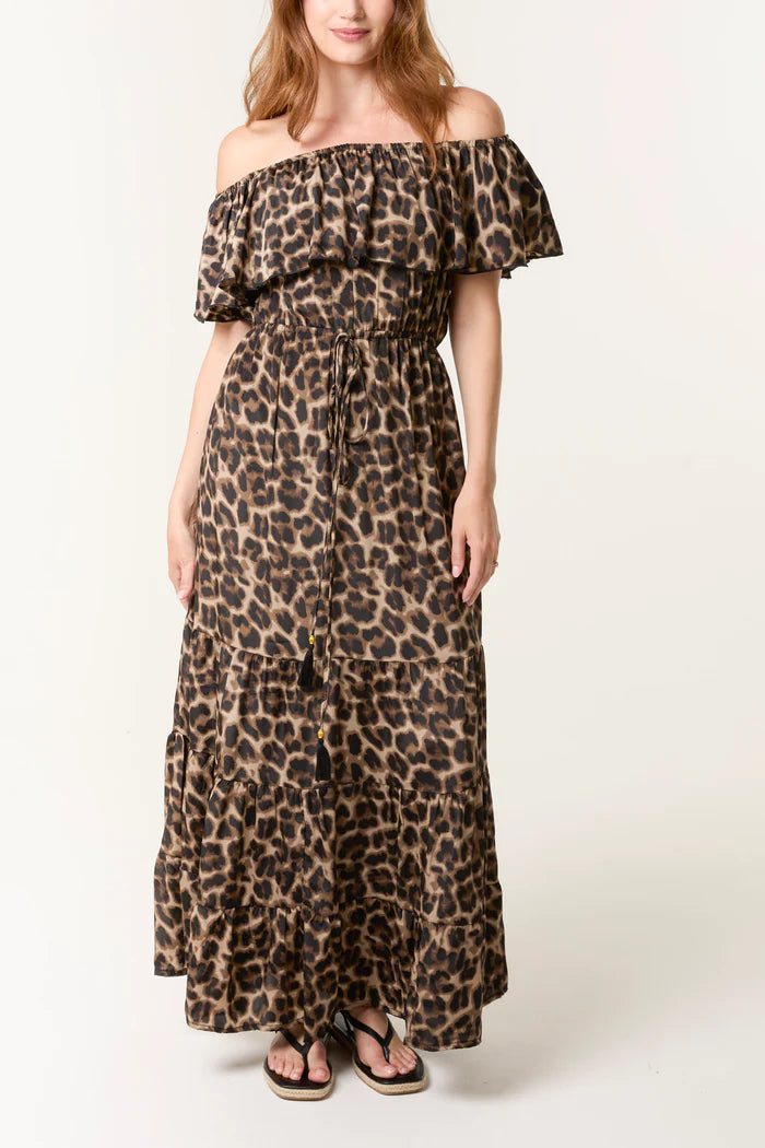 Woman wearing a leopard print off-shoulder dress on a white background